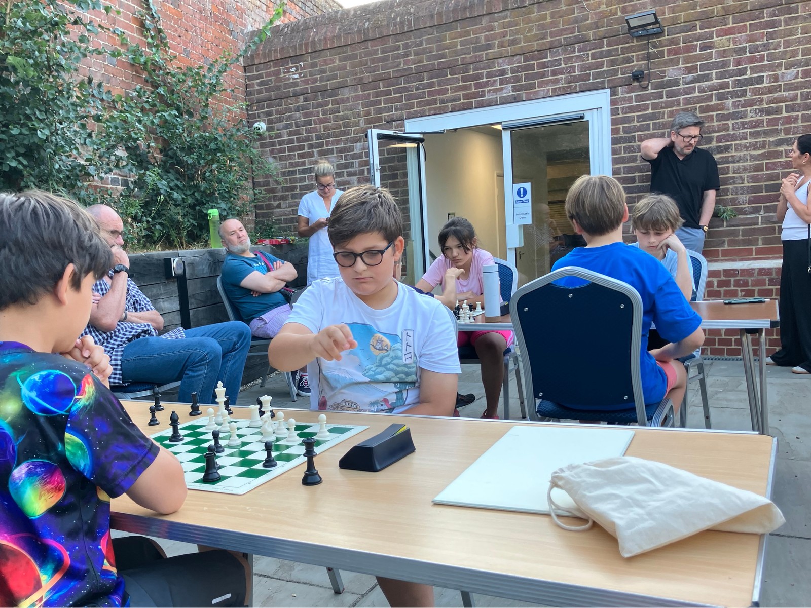 Junior players seated at chessboards during the club blitz tournament